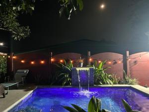 a swimming pool at night with a fountain at Villa Arenal Volcano & Privade pool in Fortuna
