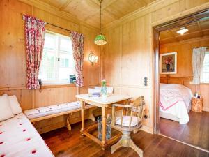 a bedroom with a bed and a table in a room at Rustikaler Bauernhof am Ammersee in Pähl