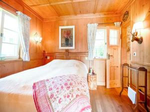 a bedroom with a bed in a room with wooden walls at Rustikaler Bauernhof am Ammersee in Pähl
