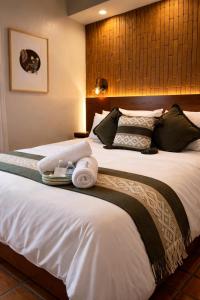 a hotel room with a large bed with towels on it at Hotel Boutique Casa Gopar in Ocotlán de Morelos