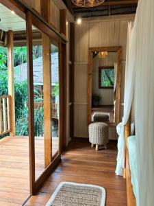 a room with a door open to a porch at The Angkayo in Angkayo