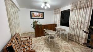a living room with chairs and a table and a couch at CATTLEYA Casa Hospedaje in Nueva Cajamarca