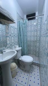 a bathroom with a toilet and a sink at CATTLEYA Casa Hospedaje in Nueva Cajamarca +20 photos
