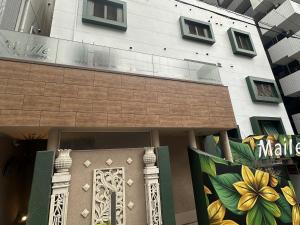 a building with a front door with a painting on it at Hotel Maile in Tokyo