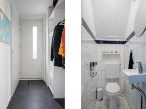 a white bathroom with a toilet and a sink at Getaway with Bikes & Whirlpool in Grou +34 photos