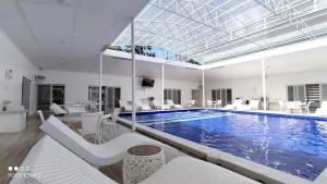 a large swimming pool with white chairs and a swimming pool at Zoobic Glampz in Subic
