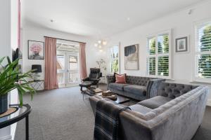 a living room with a couch and two chairs at Altitude Apartment in Martinborough