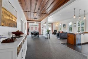 an open kitchen and living room with a wooden ceiling at Altitude Apartment in Martinborough