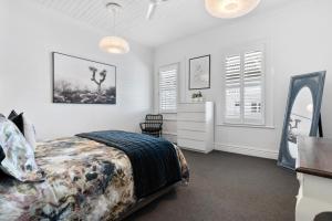 a bedroom with a bed and a dresser and a mirror at Altitude Apartment in Martinborough