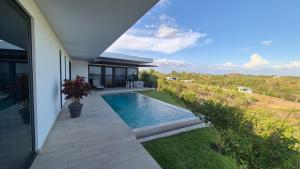 a house with a swimming pool in the yard at Hermosa Bay Oceanview Villa in Boca Chica