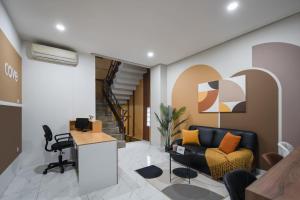 a living room with a couch and a desk at Cove Casa Dyna in Jakarta