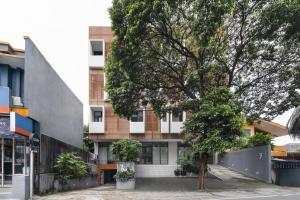 a building with a tree in front of it at Cove Casa Dyna in Jakarta
