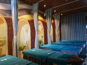 a room with four blue beds in it at Tam Coc Vivana Hotel in Ninh Binh