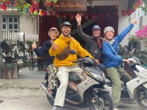 a group of people riding on a motor scooter at Tam Coc Hope House in Ninh Binh
