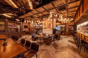 a restaurant with tables and chairs and a bar at Shangri-La Songbei, Harbin in Harbin