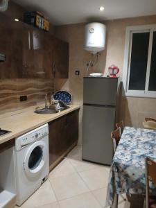 a kitchen with a refrigerator and a washing machine at Appartement hay lmatar in Nador +7 photos