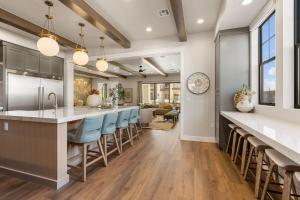 a kitchen with a large island with blue bar stools at The Boardwalk home in St. George
