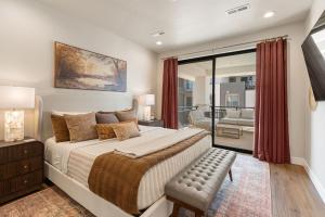 a bedroom with a large bed and a balcony at The Boardwalk home in St. George