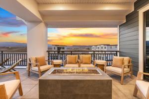 a patio with a fire pit on a balcony at The Boardwalk home in St. George