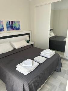 a bedroom with two beds with towels on the bed at Casa Soleada - Beautiful Villa, Best Corner by Pools, Resort Facilities,Full Kitchen, 3 Terraces, Internet in Marbella