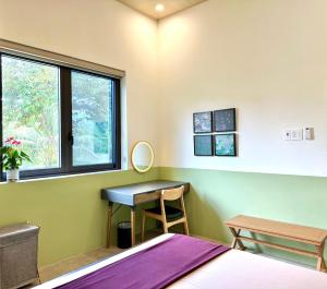 a bedroom with a bed and a desk and a window at Rustic Homeaway - Stay with the local in Phong Ðiền +29 photos