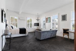 a bedroom with a bed and a tub in a room at Altitude Studio in Martinborough