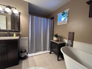a bathroom with a tub and a sink at Mountain Guesthouse Bed and Baking in Radium Hot Springs +48 photos