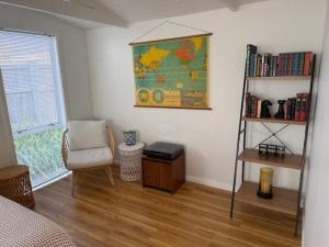 a room with a map on the wall and a chair at Sailrock Studio in Mangawhai +1 photo