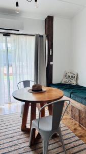 a living room with a table and chairs and a bed at Bluff Shacks in Whitemark