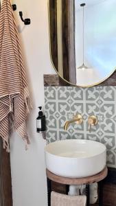 a bathroom with a sink and a mirror at Bluff Shacks in Whitemark