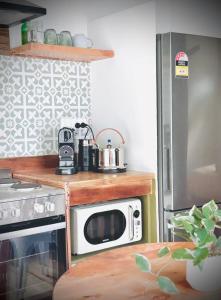 a kitchen with a microwave on top of a stove at Bluff Shacks in Whitemark