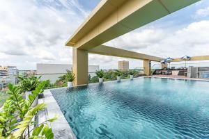 a swimming pool on the roof of a building at Cosmo Stars Hotel Bạc Liêu in Bạc Liêu