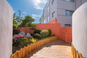 a fence in front of a building with a garden at MEI DI DU JIA HOTEL in Shanghai