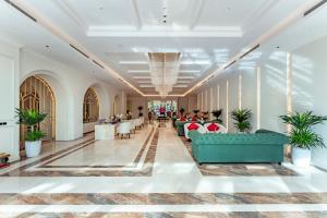 a lobby with couches and tables in a building at Cosmo Stars Hotel Bạc Liêu in Bạc Liêu +92 photos
