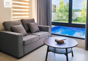 a living room with a couch and a table and a pool at Maria Clara Villas in Panabo