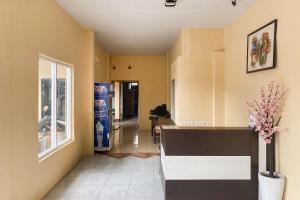 a hallway of a home with a counter and a window at RedDoorz at Hotel Warna Palopo in Palopo