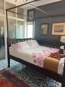 a bedroom with a large bed with a wooden frame at Charming quirky Thai style house in Hua Hin +12 photos