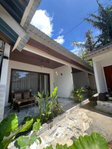 a view of a house with a patio at Andre Homestay in Kuta Lombok