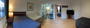 a living room with a couch and a tv in a room at Marland Motel in Powell River