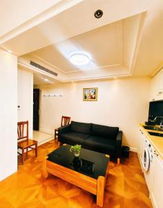 a living room with a couch and a table at Pu Yu Apartment in Shanghai