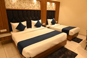 a hotel room with two beds in a room at Hotel Sahil Suites in Katra