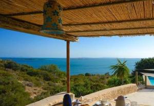 a table with a view of the ocean from a house at ksour in Tunis
