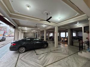 a car parked in the middle of a garage at Hotel Amrit in Bharwain +3 photos