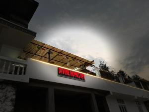 a sign on top of a building with a dining room sign at Divine Homestay Dirang in Dirang Dzong