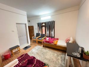 a living room with a bed and a couch at Divine Homestay Dirang in Dirang Dzong