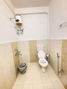 a bathroom with a toilet and a trash can at Divine Homestay Dirang in Dirang Dzong