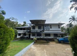 a house with a solarium on top of it at Quiet Canopy homestay in Padinjarathara