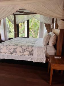 a bedroom with a bed with a canopy at Mi Casa - The gem of Ijen in Banyuwangi +206 photos