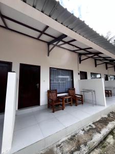 a patio with two chairs and a table on a house at SALWA Homestay in Kuta Lombok +13 photos