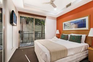 a bedroom with a large bed and a window at Nouvelle in Noosaville